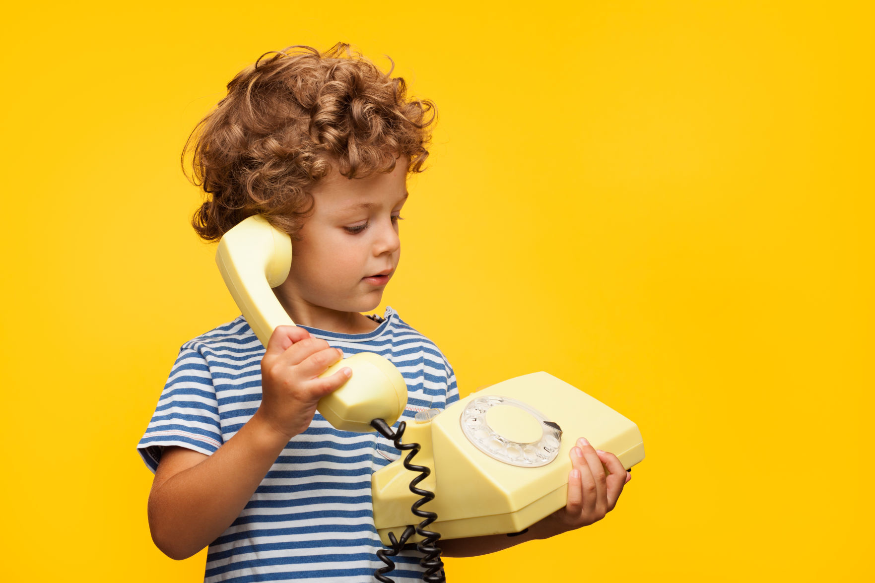 Boy talking obsolete phone